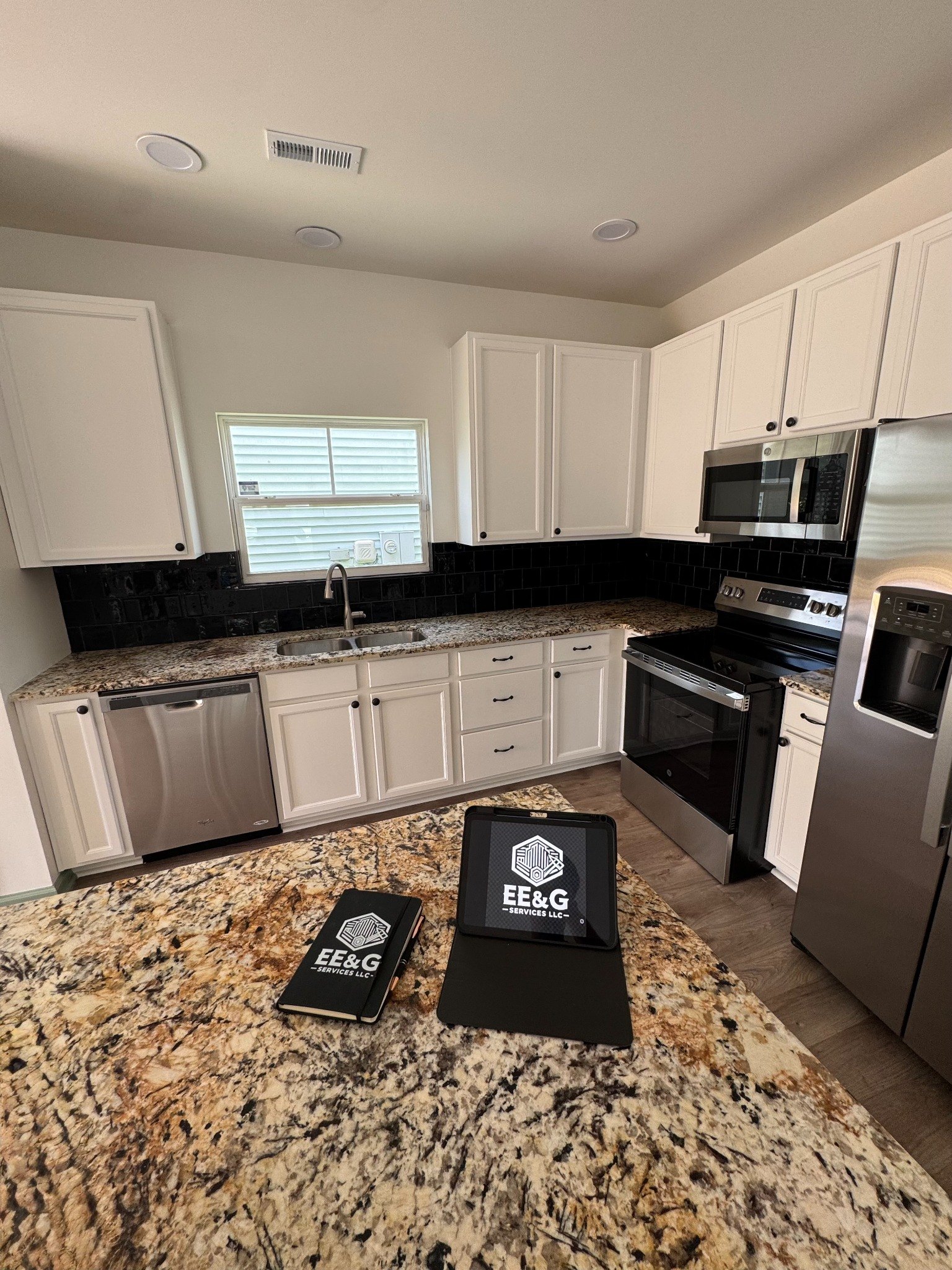 Freshly painted white kitchen with EE&G branded materials