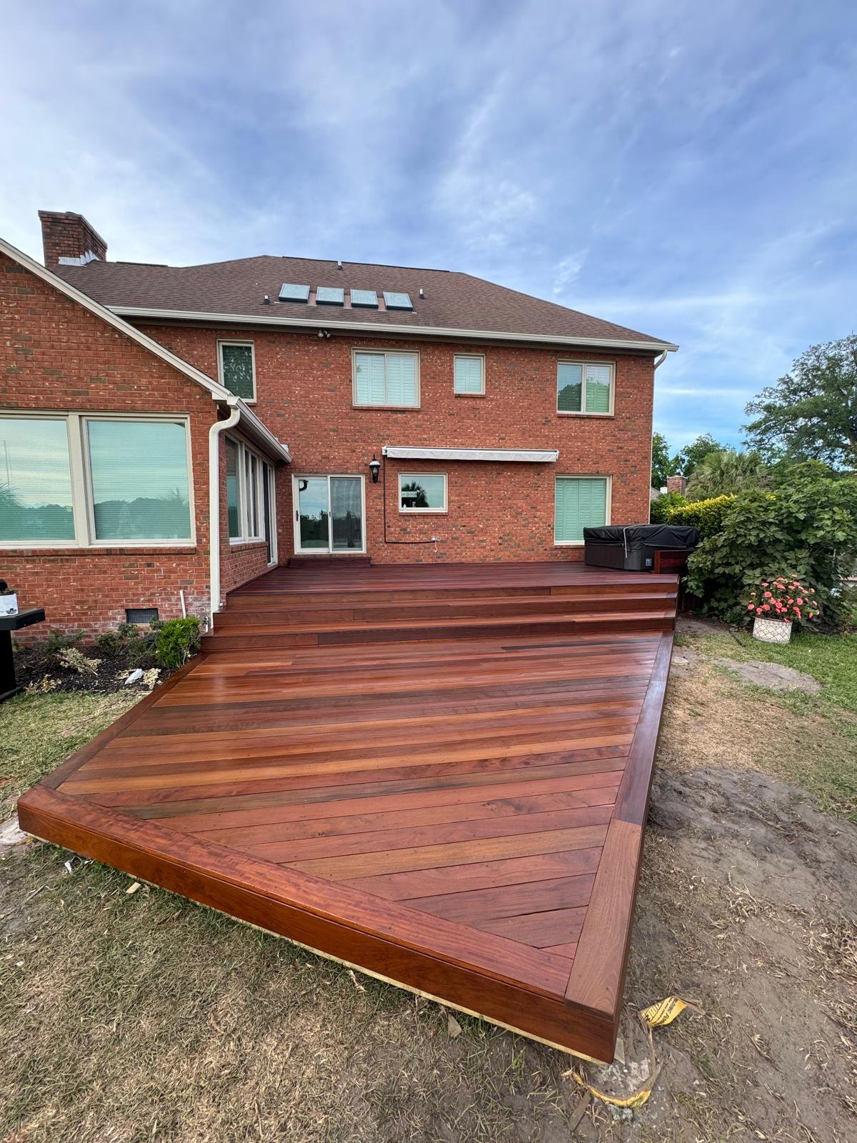 Large finished hardwood deck at the rear of a home
